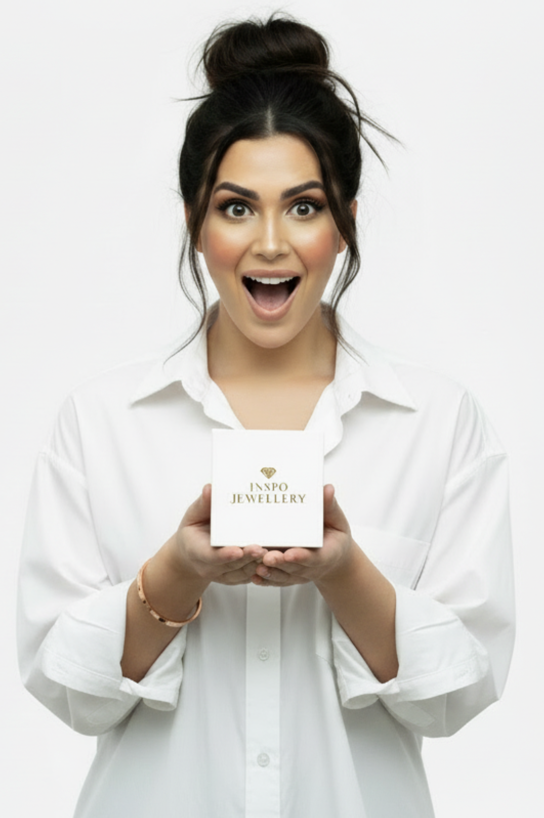 Woman holding a white box with 'INSPO JEWELLERY' branding against a white background