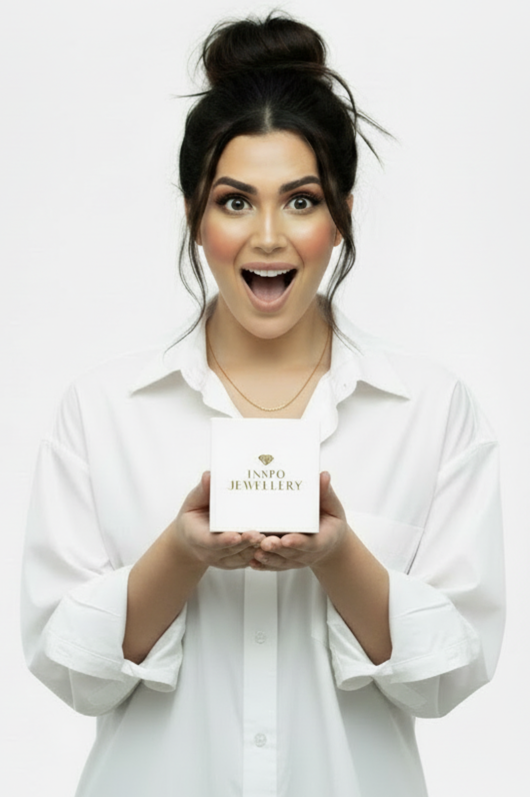 Woman holding a white jewelry box with 'Inspo Jewellery' branding on a white background