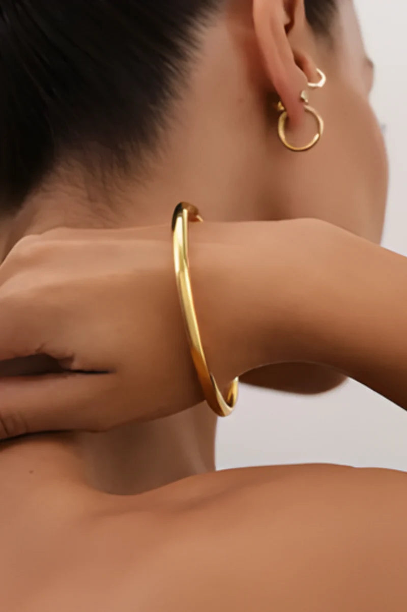 Close-up of Margot Bangle – tarnish-free 18K gold plated finish with fine detailing