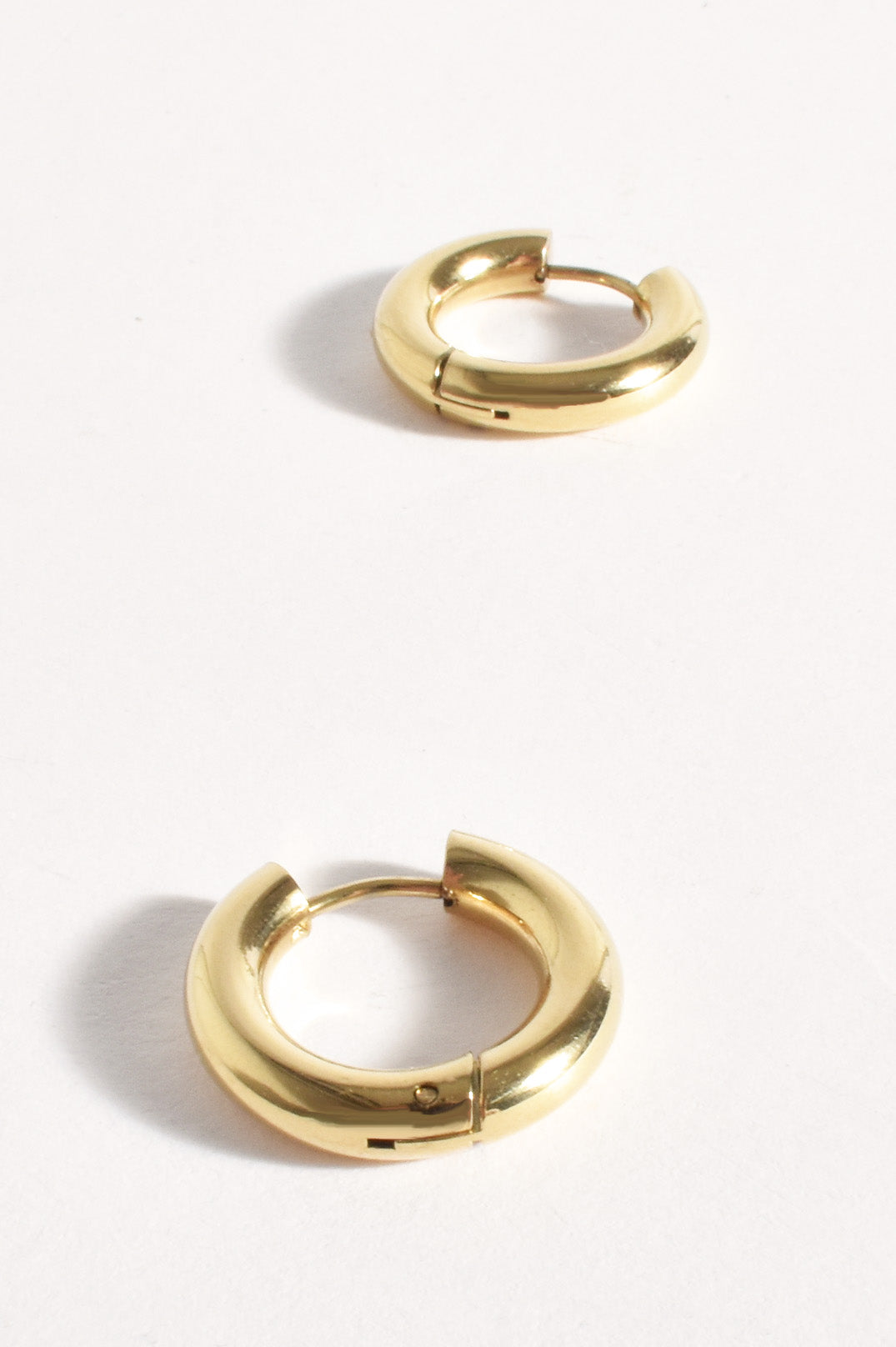 Gold hoop earrings on a white background